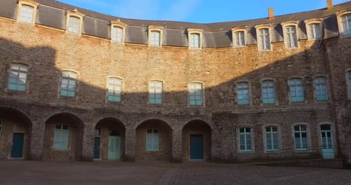 Historic Stone Building Courtyard on Sunny Day