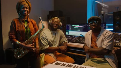 Portrait of Happy Black Jazz Band with Sax and Keyboards in Recording Studio