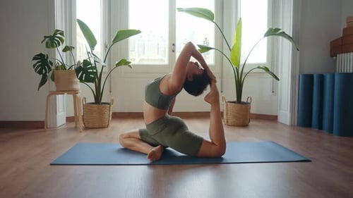 Woman Practicing Yoga Pose at Home