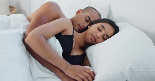 Loving Couple Sleeping Peacefully in White Bed