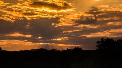 Dramatic Golden Sunset with Sun Rays and Clouds