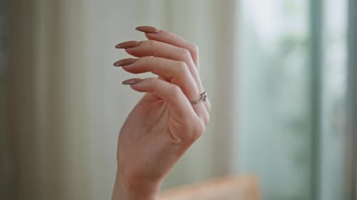 Elegant Hand Displays Engagement Ring Indoors