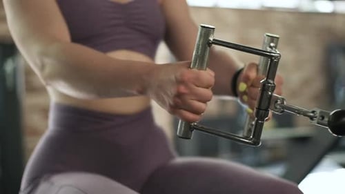 Gorgeous Female Professional Bodybuilder Doing Workout Exercises in Gym