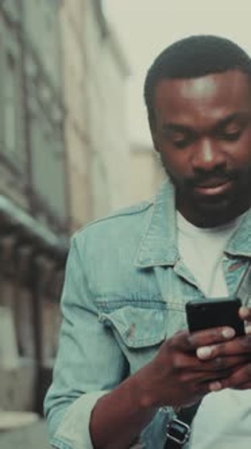 Man Using Smartphone in Urban Environment