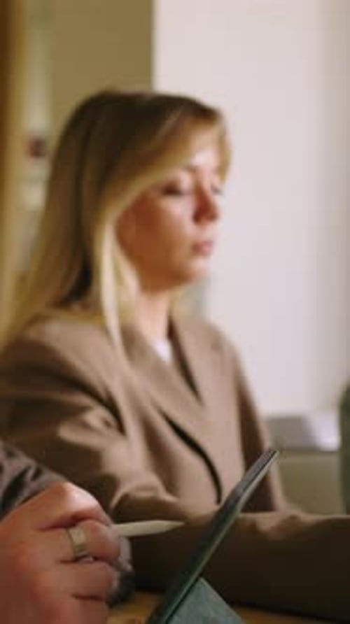 Business Professionals Collaborate Using Tablet at Office Workplace