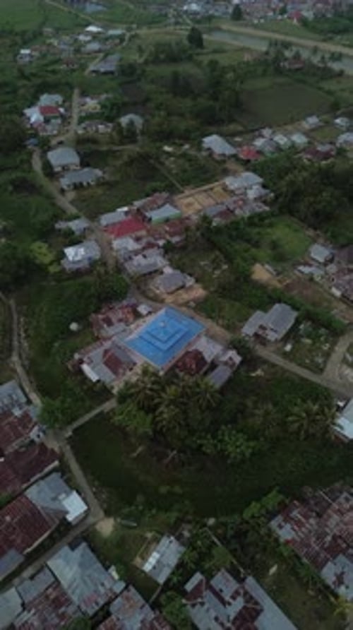 Vertical aerial footage of Small Village in the Afternoon. Aerial View of Tualango Village in Goront