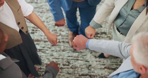 Above, business people and fist bump in office with success for company objective, goal and target