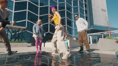 Young And Stylish Female Hip Hop Dancer Freestyling On City Street In the Circle Of Fashionable Fr
