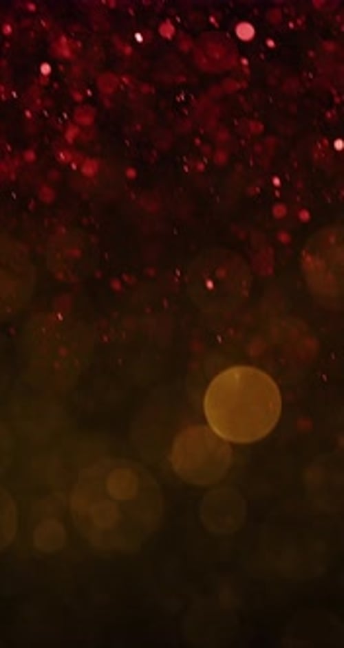 Red Particles Cascade With Yellow Bokeh