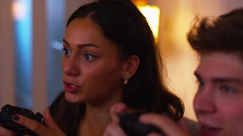 Young Adults Concentrating While Gaming Indoors