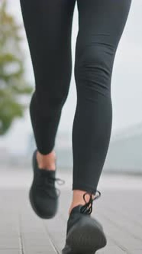 CloseUp of Woman Jogging in Black Leggings and Sneakers on Outdoor Fitness Path