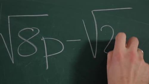 Writing Math Equations with Chalk on Green Board