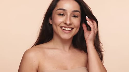 Gentle Touch on Healthy Skin Against Studio Background
