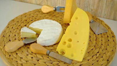 Cheese Variety on Woven Mat with Cheese Utensils