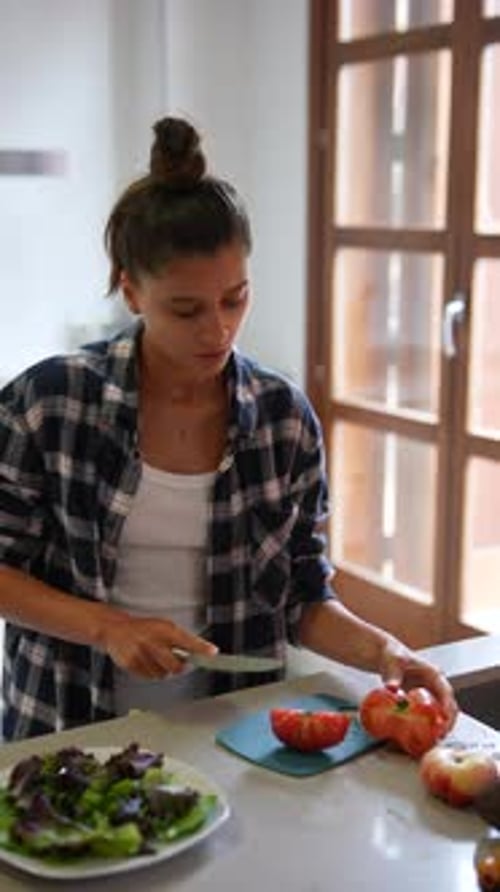 Woman Prepares Healthy Salad in Bright Kitchen