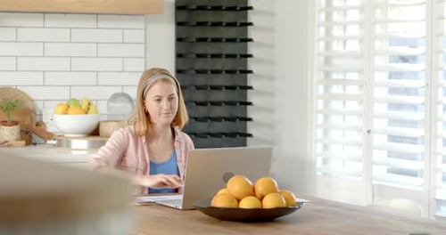 Young Woman Working at Home on Laptop