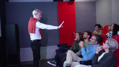 Speaker Engaging with Audience in Slow Motion During Presentation in Auditorium