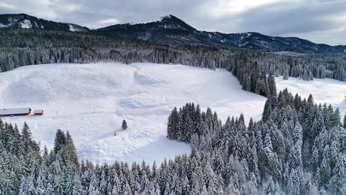 Thick snow covers the slope of the hill at the picturesque mountains.