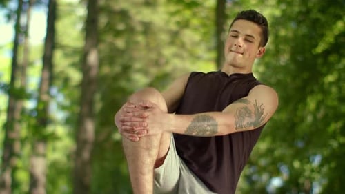 Man Stretching Outdoor. Male Runner Warming Before Running Marathon. Fitness Man Stretches