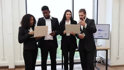 Diverse Business Team with Laptops in Modern Office