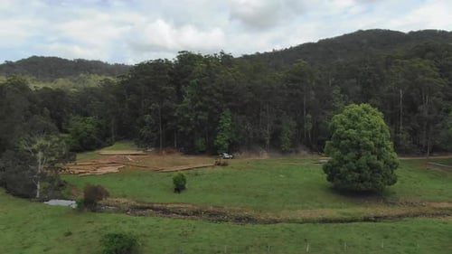 Logging lumber activity near forest in Argents Hill, Australia. Aerial forward