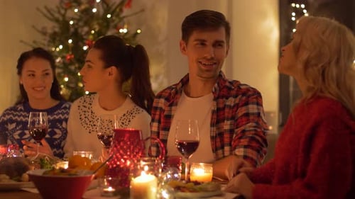 Friends and family celebrating Christmas at festive dinner