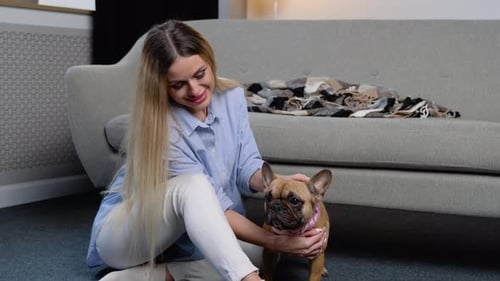 Woman Pets her Dog in her Living Room