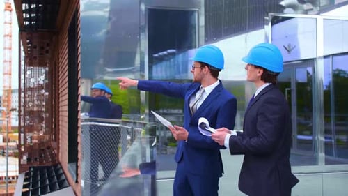 Real Estate Developers in Helmets New Office Construction Confident Business Men and Architect