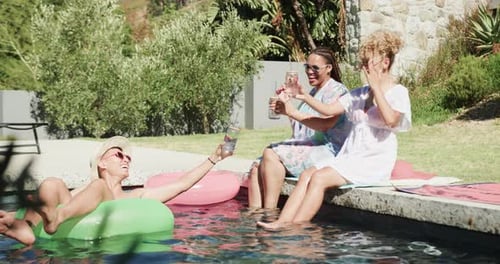 Friends Toasting at Poolside Get Together