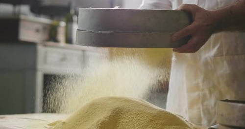Chef Sifting Flour to Create Fine Meal