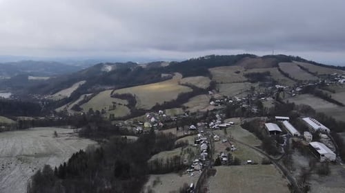 A flight over the countryside with a path leading through the trees and a view of the surrounding th