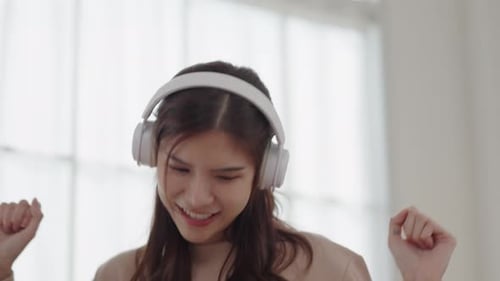 Woman Happily Dancing While Listening to Music