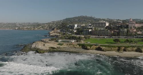 a beach with a body of water and buildings