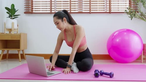 Woman in Sportswear Using Laptop on Yoga Mat