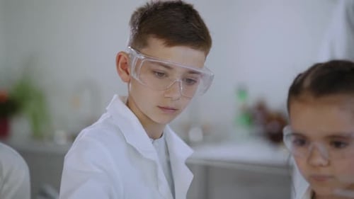 Children in Lab Coats Doing Science Experiments