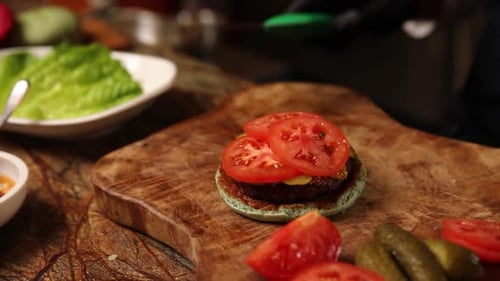 Burger Being Assembled on Cutting Board