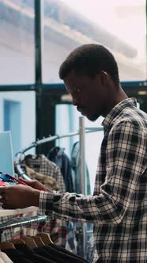 Young Man Shopping for Eyeglasses in Fashion Store