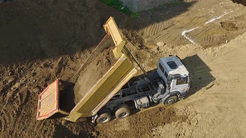 Aerial View of Dump Truck Unloading Soil