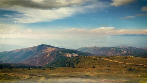 Scenic Mountain Landscape Under Cloudy Blue Sky