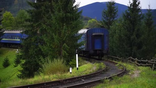 Outgoing train on a background of mountains.