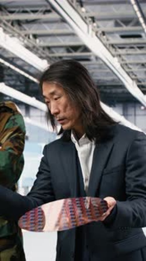 Men Examining Silicon Wafer in Factory