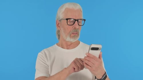 Casual Old Man using Phone on Green Background, Portrait