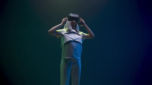 Woman Using Virtual Reality Headset and Controllers
