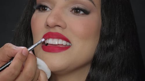 Woman Getting Lipstick Applied by Makeup Artist