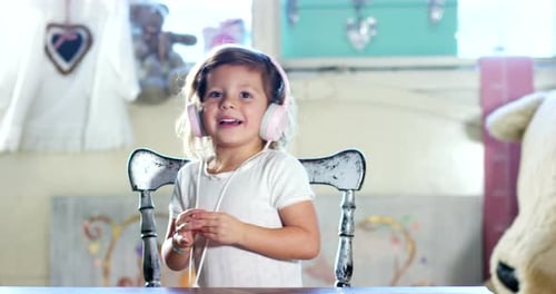 Happy Girl Listens to Music on Headphones