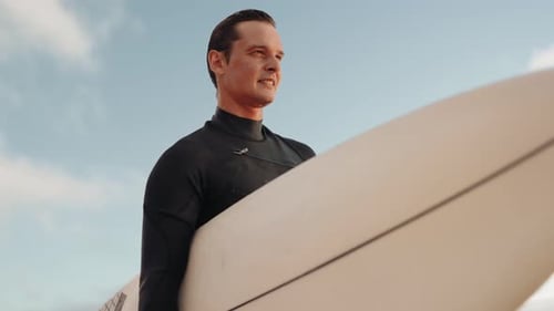 Surfer Holding Surfboard On Beach