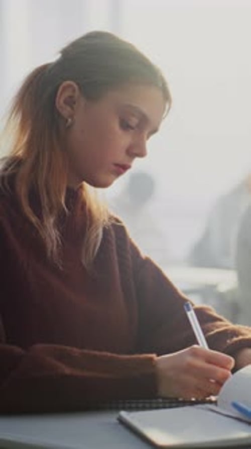 Teenagers Writing Completing Task in Classroom