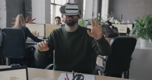 Businessman Wearing Augmented Reality Glasses Gesturing Playing Game Relaxing in Office During Break