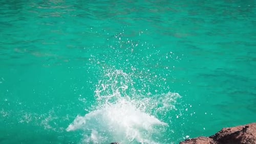 man jumping into sea water