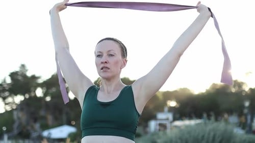 Woman Exercising with Resistance Band Outdoors